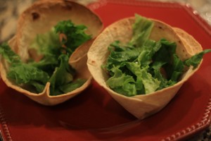 Fill cups with ¼ shredded lettuce.