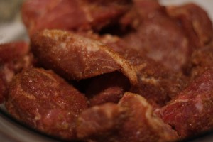 Season pork with the rib rub and make sure chunks are covered well.