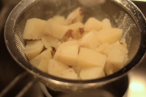 Remove from heat.  Strain the potatoes.  Remove the garlic cloves and discard.