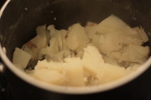 Put potatoes back into saucepot.  Turn heat to low and stir the potatoes to dry them out for about a minute.  Turn off heat.