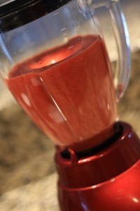 Put 2lbs (about ½) of the strawberries into the blender and puree until smooth.  Set the remaining strawberries aside; you’ll need them later.