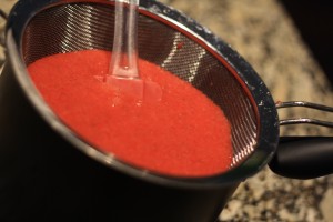 Strain the puree into saucepan to remove seeds.