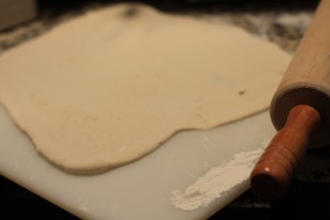 Roll out the pizza dough into desired shape.  Par-bake the dough in the oven on 425 degrees Fahrenheit for about 10 minutes.