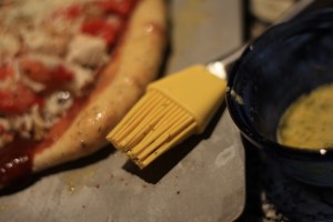 Brush the Garlic Butter Sauce onto crust.