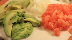 Chop 1 Roma tomato, ½ onion, and cut avocado in slices.  Shred 1 cup of lettuce.