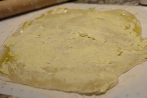 Spread the garlic butter mixture all over pizza dough.