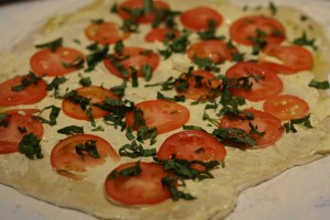 Layer the tomatoes and basil on top of dough.