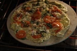 Sprinkle some of the breadcrumbs onto the pizza stone.  Transfer the pizza carefully to the pizza stone.  The stone will be extremely hot, so use oven mitts.  If you're using a baking sheet, sprinkle the sheet with the crumbs and transfer the pizza to the baking sheet.  (You could also assemble the pizza on the baking sheet without preheating the baking sheet)