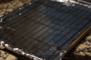 Preheat the oven to 400 degrees Fahrenheit.  Prep a baking sheet by lining it with aluminum foil and placing a baking rack on top.  Spray the rack with cooking spray.