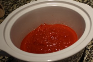 In the slow-cooker, pour in the crushed tomatoes.