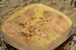 Pour the remaining ½ cup dressing on top of chicken.  Sprinkle the remaining ½ tsp garlic powder and 1/8 tsp red pepper flakes.
