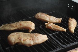 Once grill is heated, place each chicken breast onto grill carefully using tongs. 