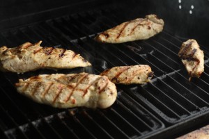 Turn the chicken halfway through cooking using tongs.  Chicken is done when the internal temperature reads 165 degrees Fahrenheit when checked with a meat thermometer.