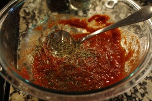 Add the other ½ of the spice mix to the pizza sauce, and stir to combine.