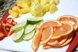 Prep the fruit by slicing the ½ grapefruit, 1 lime, and 1 peach into thin slices.  Remove the hull from the strawberries, and cut into slices.  Cut the pineapple into chunks.