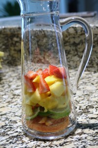 Place the fruit into a pitcher. 