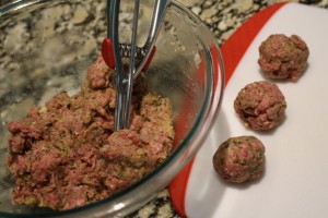 Using a cookie scoop, scoop out meat and roughly shape into ball forms.  I use a cookie scoop, so they are relatively all the same shape and size.  Set onto a cutting board or baking sheet.