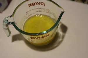 In a mixing cup, combine the 2 beaten eggs, olive oil, and water.  Stir to combine.