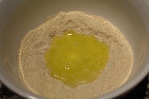 Add the egg mixture into the well of the flour mix.
