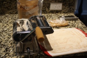 I usually set up a little “station” for my pasta rolling.  I lightly flour a cutting board, and set it on the end where the pasta comes out.  I keep extra flour handy for dusting the pasta, cutting board, my hands, and machine.  I also like to keep some plastic wrap around.  You’ll want to keep the pasta covered, so it doesn't dry out too much.