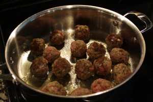 When meatballs are ready to turn, they should be easy to turn.  They may not be ready all at once.  You’ll want a nice caramelization color on them.