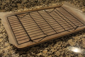 Lay a sheet of waxed paper onto a baking sheet.  Place a wire cooling rack on top of the waxed paper.