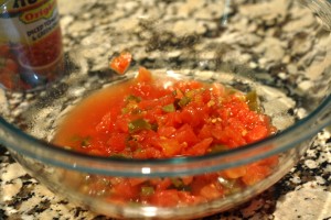 Empty the can of diced tomatoes and green chilies into a mixing bowl.