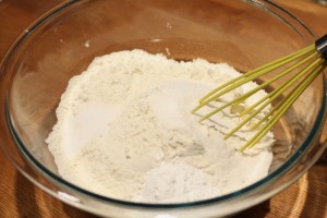 Preheat the oven to 400 degrees Fahrenheit.  Combine the flour, salt, baking powder, and sugar.  Whisk to combine.