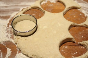 With a lightly floured biscuit cutter, cut out biscuits. 