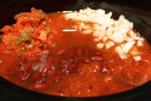 Add the kidney beans, diced tomatoes with diced green chilies, and chopped onion to the slow-cooker.  Stir to combine.  Next add in the broth and beer.