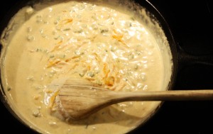 Add the 1 and ½ cups of cheese to the sauce and stir.  The cheese will also help the sauce to thicken more.