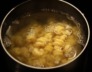 Start by cooking your pasta according to package instructions.  When pasta is cooked, scoop out ½ cup of the pasta water and set aside to use later.