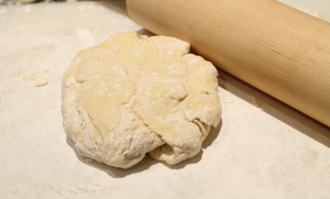 Dust the work surface with a little flour.  Be sure to dust your hands, rolling pin, and top of dough. 