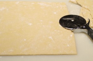 Trim around the edges to make a rectangle with a pizza cutter.  Place the scraps to the side.
