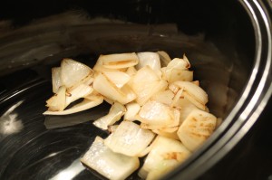 Carefully remove the onion from the skillet with tongs or a spoon, and transfer to a slow cooker.