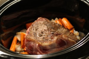Add the shoulder roast to the slow cooker.