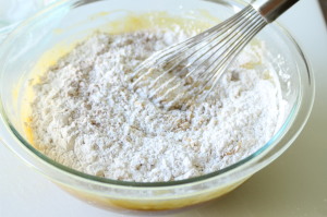 Gradually add the flour mixture into the wet ingredients a little at a time and whisk to combine until all of the flour mixture has been incorporated.