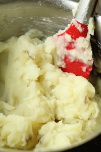 Stir milk into potatoes