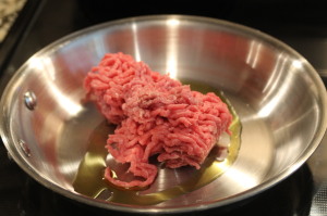 Brown the ground beef in a skillet on medium heat.  