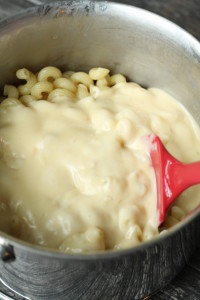 pour cheese sauce into macaroni