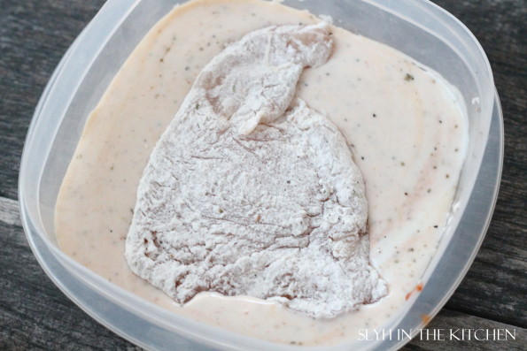 Floured chicken in buttermilk mixture